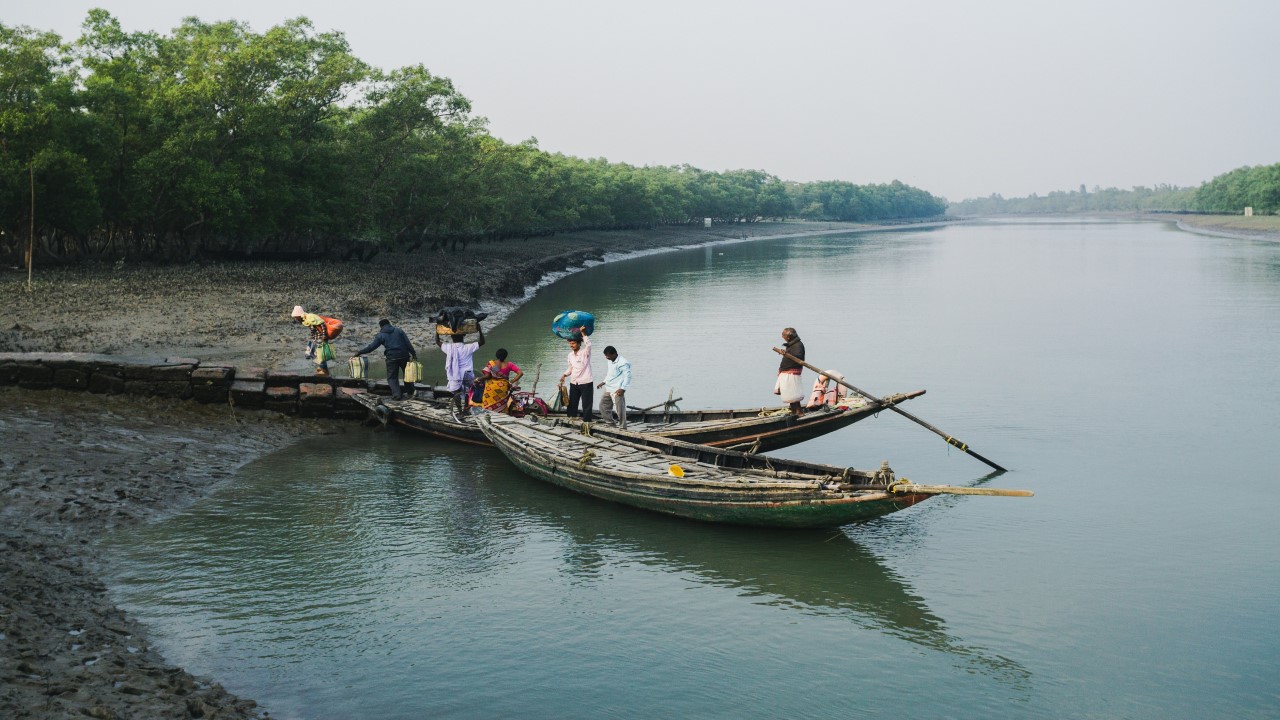 Islanders crossing the Dutta river on a ferry